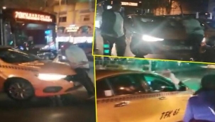 Beyoğlu'nda alınmadığı taksinin üstüne çıkarak tepki gösterdi